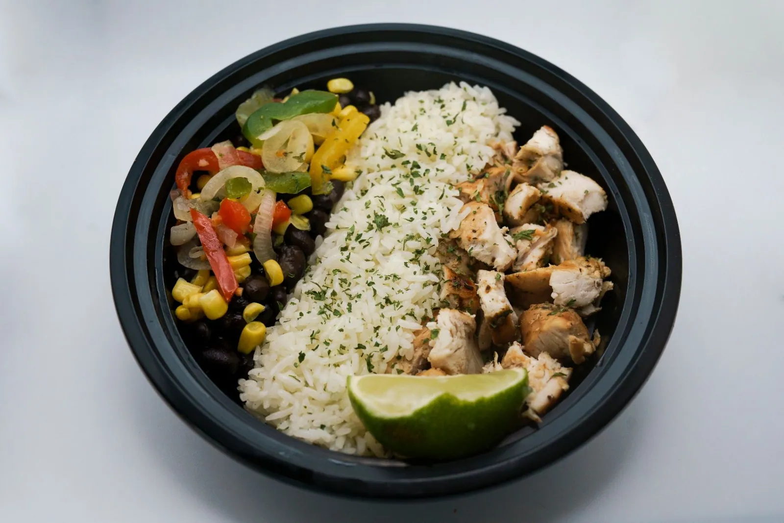 Chicken fajita bowl with rice, peppers and colorful vegetables