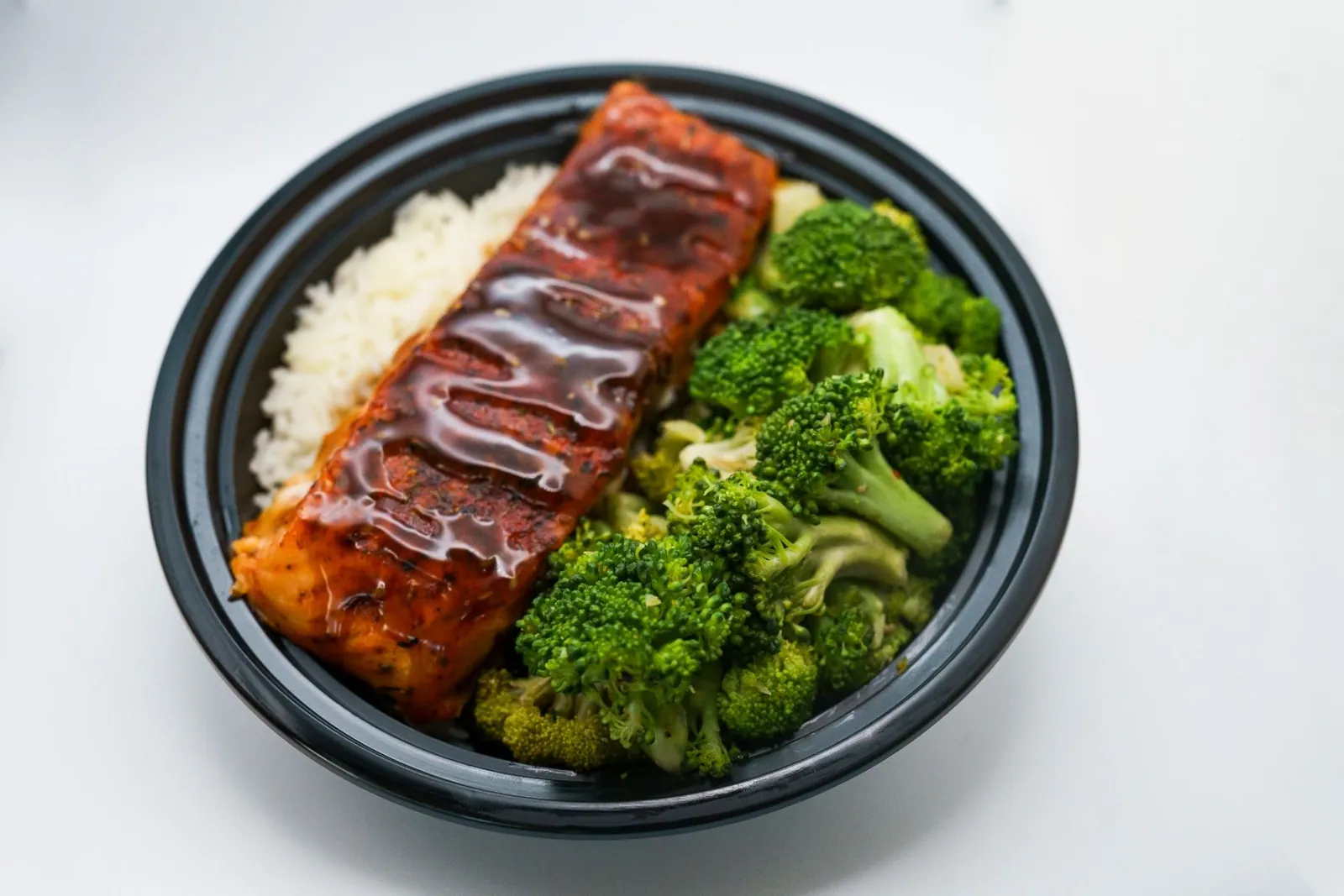 Glazed salmon served with broccoli and rice