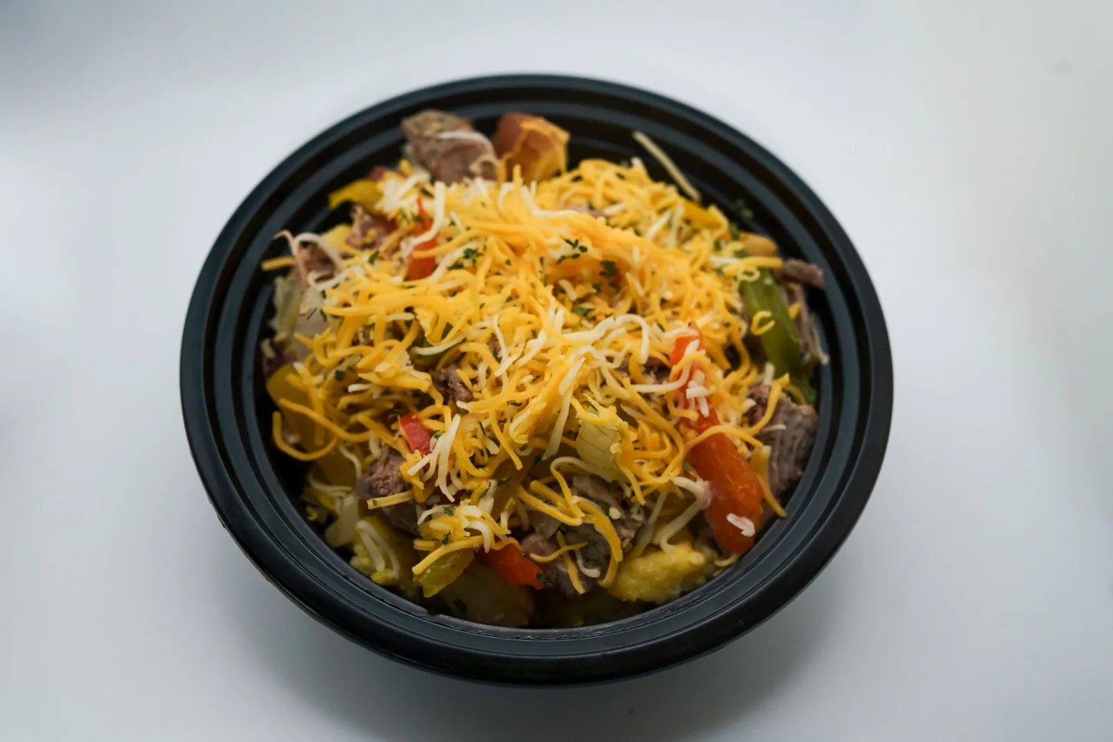 Shredded beef with rice and vegetables in a fresh meal bowl