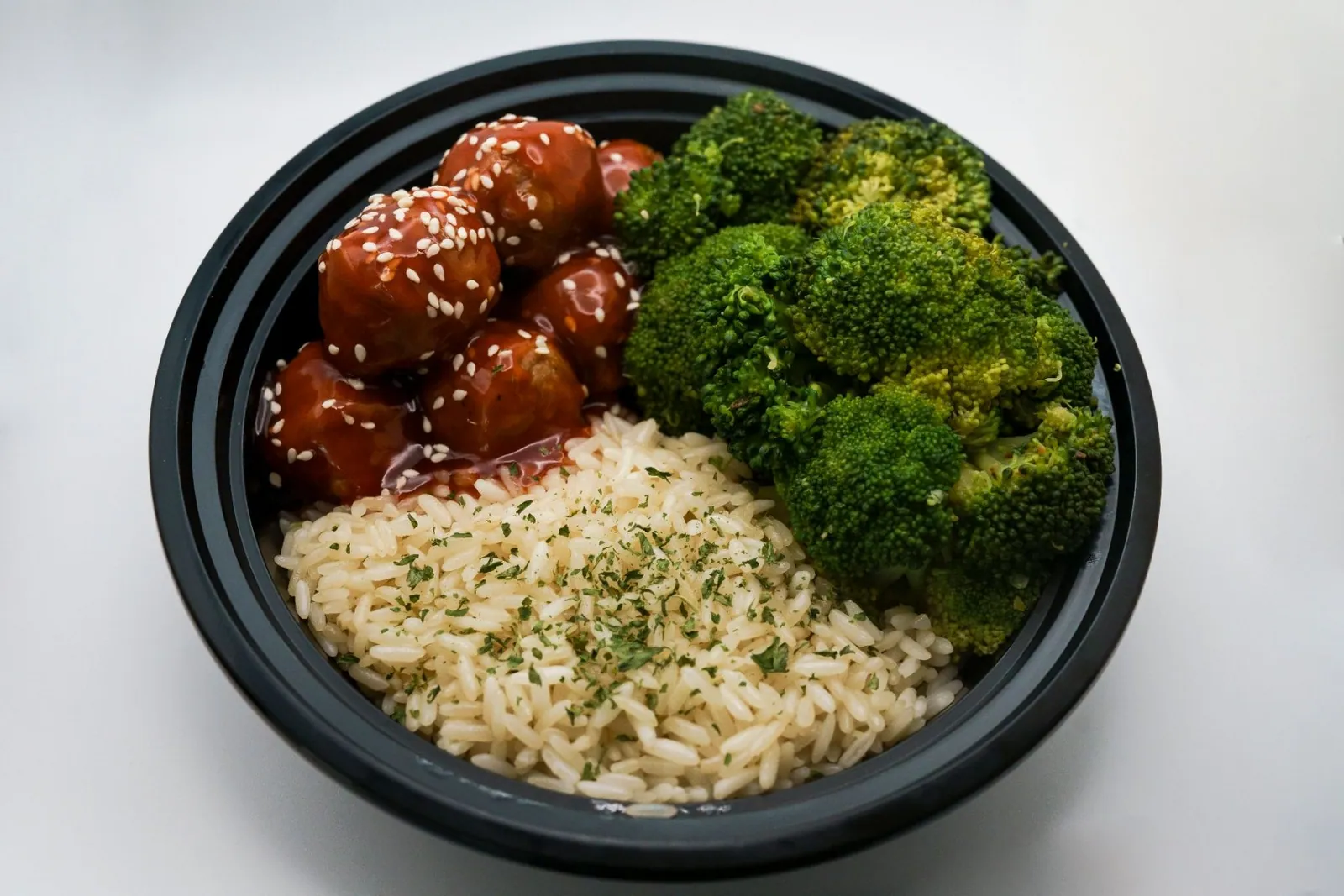 Fresh turkey meatballs with broccoli and rice in a meal bowl